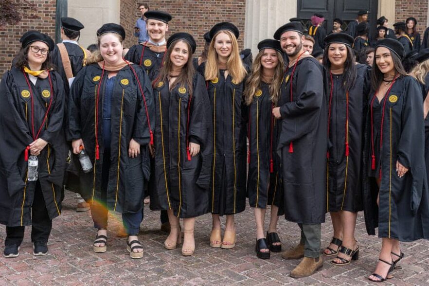 The Creative Circus graduates posing for group photo in their cap and gown